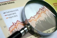 business chart magnifying glass