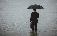 man with umbrella in flood